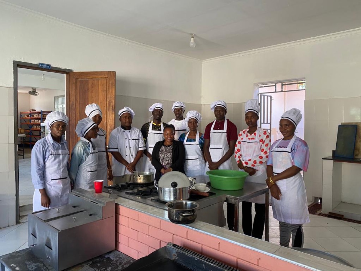 Hospitality students with their instructor in the training kitchen