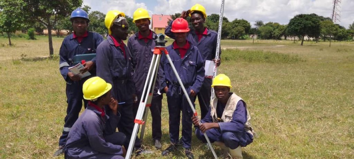 Civil engineering students with a surveying level
